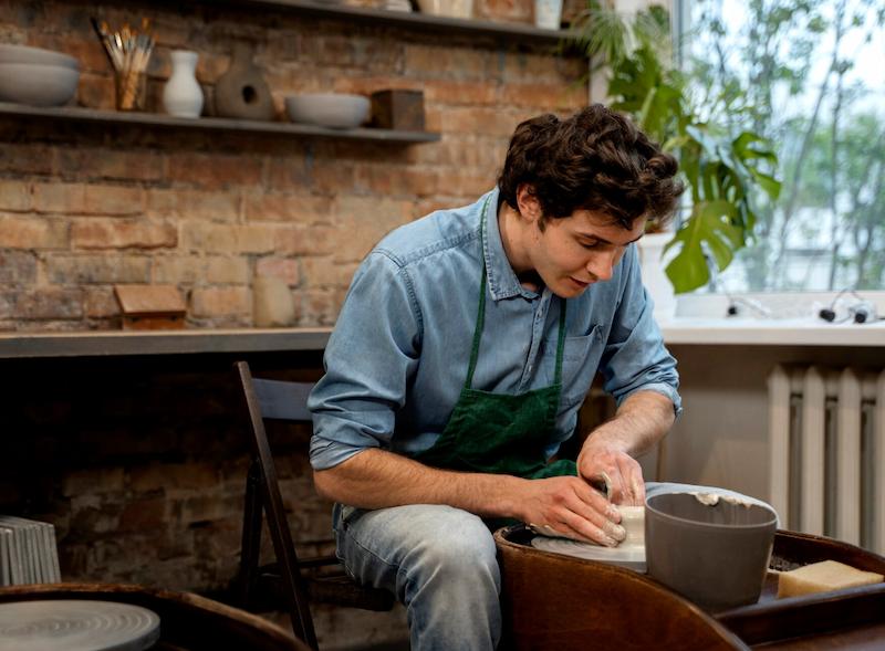 A person in work clothes at a workbench trying a hands-on craft after hours